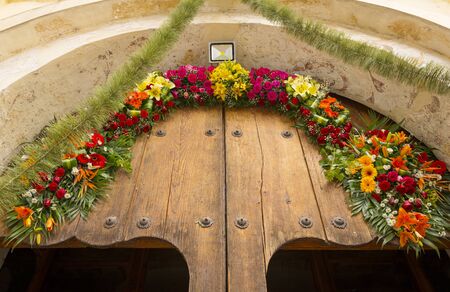 Floral archway over Mexican church doorの写真素材