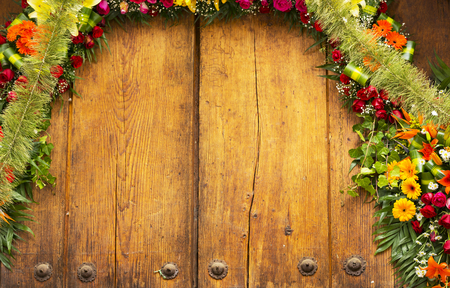 Floral archway on old wooden door with copy spaceの写真素材