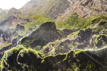 Mist over green moss from a cliff waterfall in The Sumidero Canyon, Chiapas Mexicoの写真素材