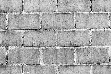 Old wall made from cinder blocks as background texture in black and whiteの写真素材