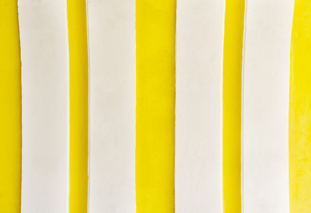Yellow stripes background on a Spanish colonial wall in Central Americaの写真素材