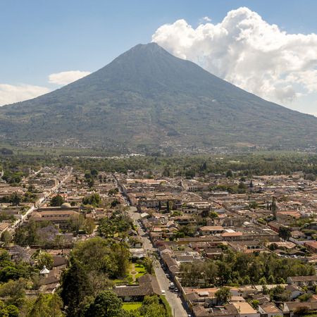 View of the city of Antigua, Guatemala with Volcan de Agua behind in Central Americaの写真素材
