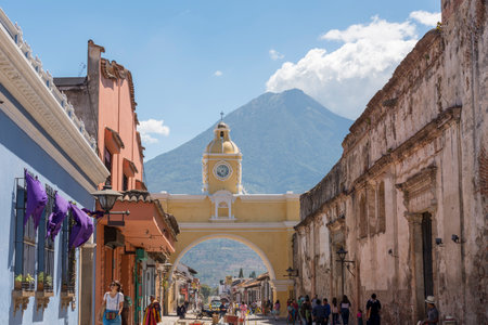 ANTIGUA, GUATEMALA - FEBRUARY 24, 2018: Unidentified people pass under the famous arch of Santa Catalina in Antigua, Guatemala.のeditorial素材