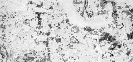 Vintage wall background texture of paint cracked and missing in stunning black and whiteの写真素材
