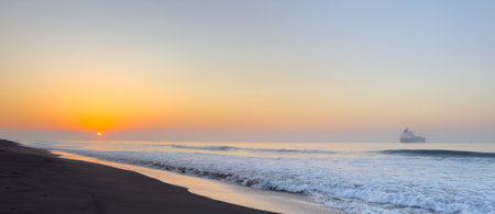 Beautiful sunrise over the black sand beach of Port of San Jose in Guatemalaの写真素材