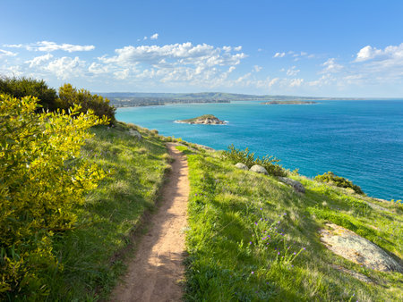 Hiking trail on The Bluff looking out over the ocean towards Granite Island in Victor Harbor on the Fleurieu Peninsula in South Australiaの写真素材