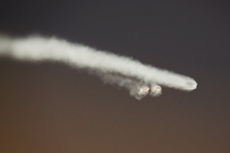 Rocket Launch in the evening sky as the boosters separate from the rocket.