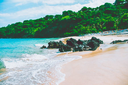 Beautiful beach, clear water of Indian ocean at sunny day. Bali, Indonesiaの写真素材