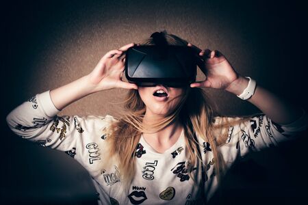blonde girl playing and enjoy in virtual reality