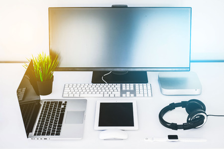 modern workplace with different gadgets, laptop, headphones, screen, computer, tablet, smart...
