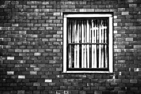window with old brick wall building in black and whiteの写真素材