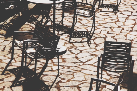 outdoor chairs with strong sunlight in summerの写真素材