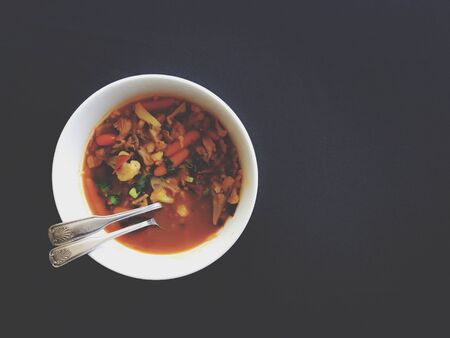 Thai curry with carrots cauliflowers and mushroom on black table clothの写真素材