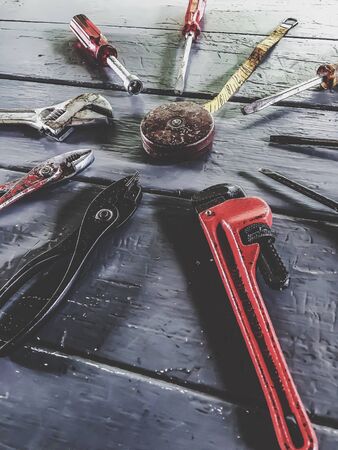 tools on the wood table with wrench tool, screwdriver, pliers and ruler