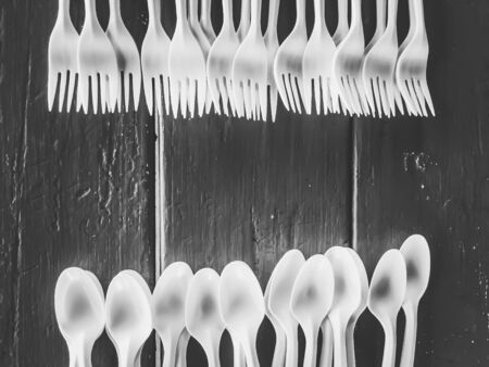 spoons and fork on the wooden table in black and whiteの写真素材