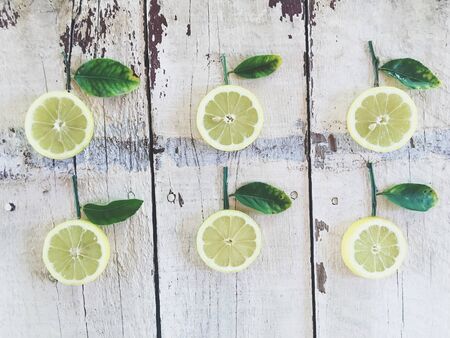 fresh lemons with green leaves on the wood