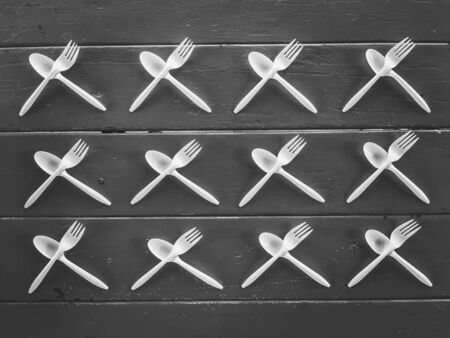 plastic forks and plastic spoons in black and whiteの写真素材