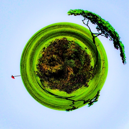golf course with trees and blue sky in small planet style