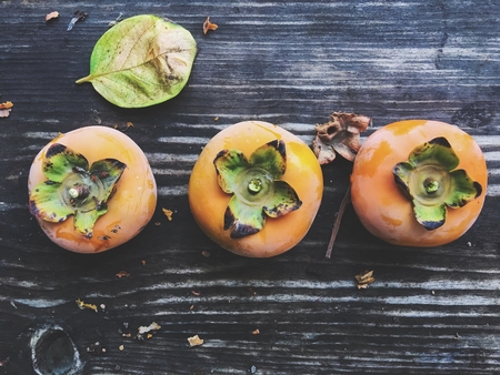 persimmons on the wooden table