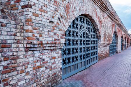 Stone wall with arched iron gate in Kazanの写真素材
