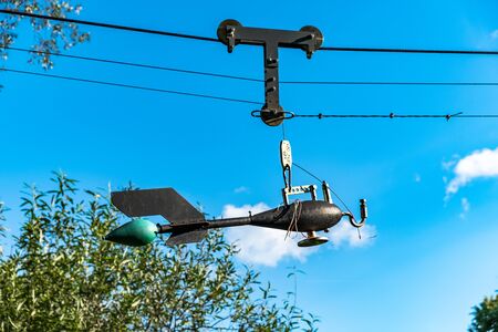 Device for measuring weather conditions hanging on metal cables over the riverの写真素材