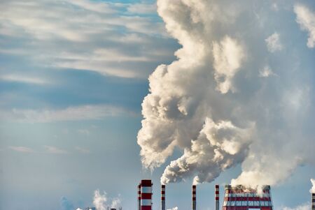 Dense steam escaping from a thermal power plant on a frosty dayの写真素材