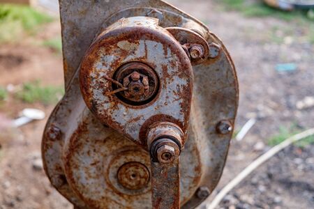 Old rusty jack standing on the green grassの写真素材