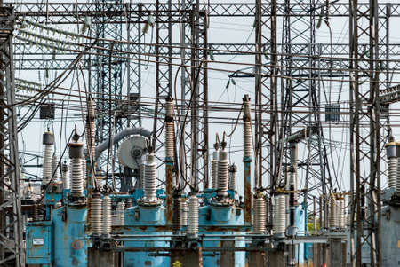 High-voltage power plant in the green zone against the background of a cloudy skyの写真素材