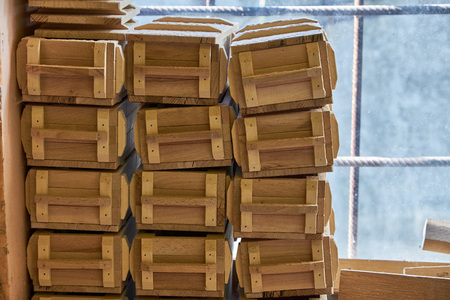 Wooden boxes of alder massif at the window in the workshop