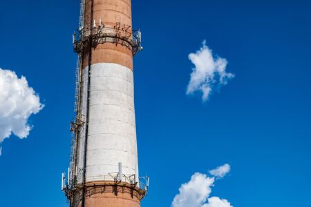 Brick boiler pipe on a cloudy sky background