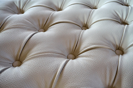 Process of manufacturing a Chester sofa made of beige leather