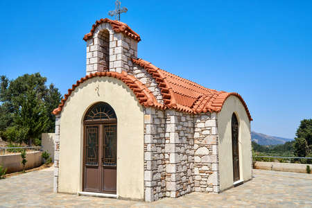 Small chapel with a tiled roof and stone wallsの写真素材