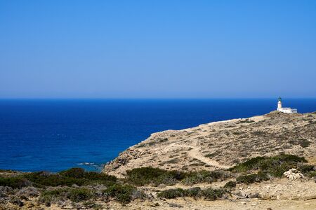 Lighthouse on Prasonisi against the background of the sea horizonの写真素材