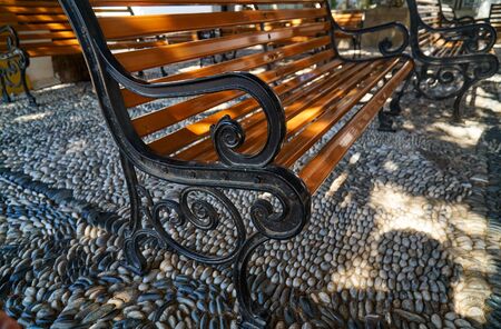 Benches standing on a pebble in a shady placeの写真素材