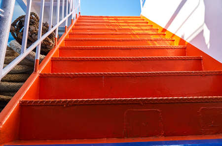 Metal ladder on the ship painted in bright orange colorの写真素材