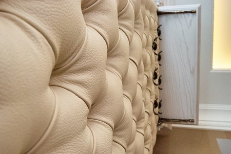 Beige leather upholstery chesterfield style. Wall in the hallwayの写真素材