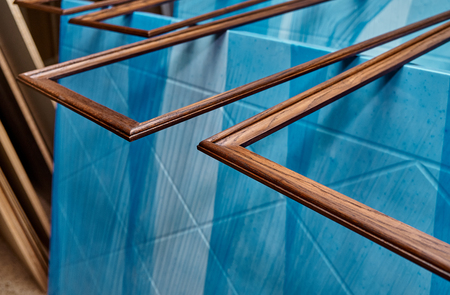 Wood door manufacturing process. Wooden moldings for the entrance door, painted in dark color. Woodworking and carpentry production. Furniture manufacture. Close-upの写真素材