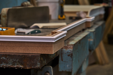 Crown molding. Home library with classic design. Work in progress. Wooden furniture manufacturing processの写真素材