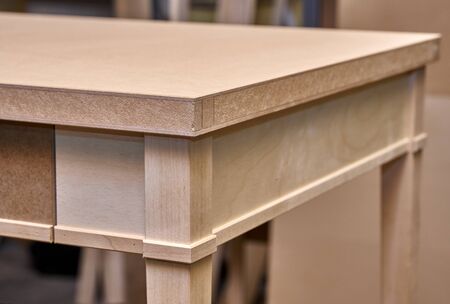 Beautiful professionally made wood writing desk in process of production in workshop. Furniture manufacture. Close-upの写真素材