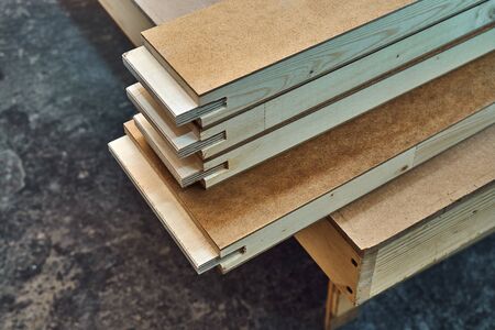Joinery. Wood door manufacturing process. Stacked door leaf elements. Woodworking and carpentry production. Furniture manufacture. Close-upの写真素材