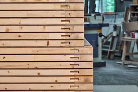 Joinery. Wood door manufacturing process. Stacked door leafs. Woodworking and carpentry production. Furniture manufacture. Close-upの写真素材