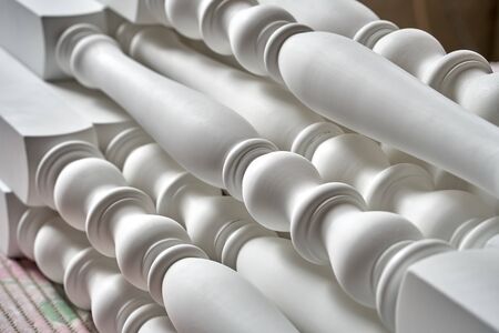 Beautiful professionally made solid wood balusters in process of production in workshop. Furniture...