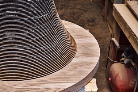 Joinery. Wooden coffee table in shape of circle being produced in workshopの写真素材