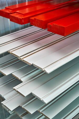 Painted furniture elements in the spray booth. Red enamel. Furniture manufacture.. Wooden furniture...