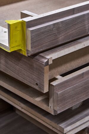 Dresser elements in a workshop. Solid wood chest of drawers. Furniture manufacture. Close-up