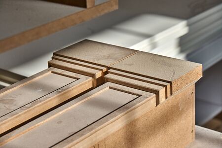 MDF table legs. Joinery. Beautiful professionally made MDF table legs in process of production in workshop. Furniture manufacture. Close-upの写真素材