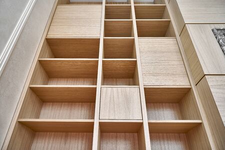 Wooden bookshelves. Wooden shelving around the fireplace. Furniture manufacture. Close-upの写真素材