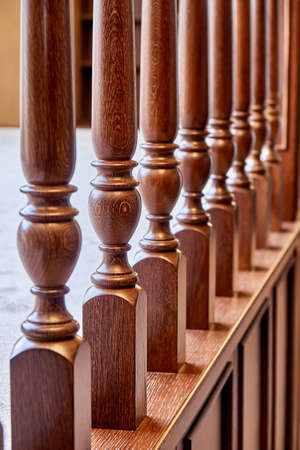 Perspective view of detail of ornate wooden balustrade in contemporary house with classic interior