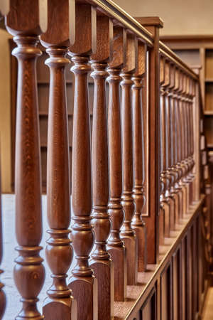 Perspective view of detail of ornate wooden railing in contemporary house with classic interiorの写真素材