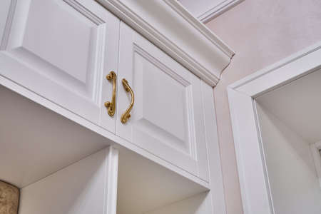 Classic white wardrobe with shelves in contemporary bright hallway. Classic furnitureの写真素材